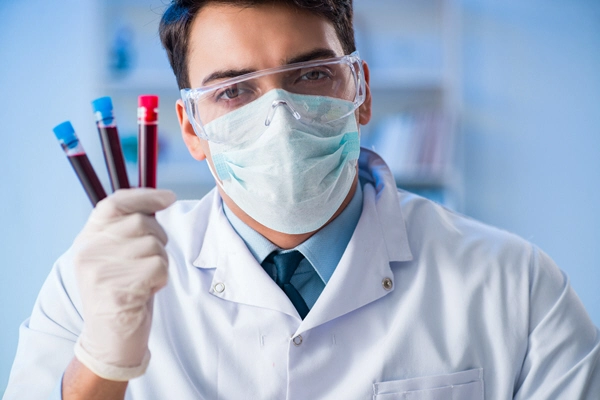 male doctor with 3 tubes of blood