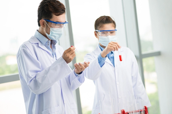 medical workers testing blood specimens in lab environment