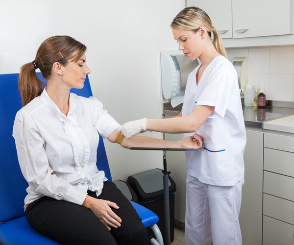 nurse preparing businesswoman for blood test in hospital nurse preparing businesswoman for blood test in hospital
