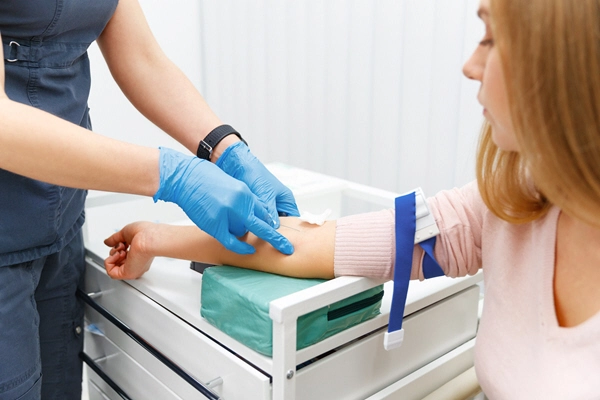 nurse takes a blood sample from the patient