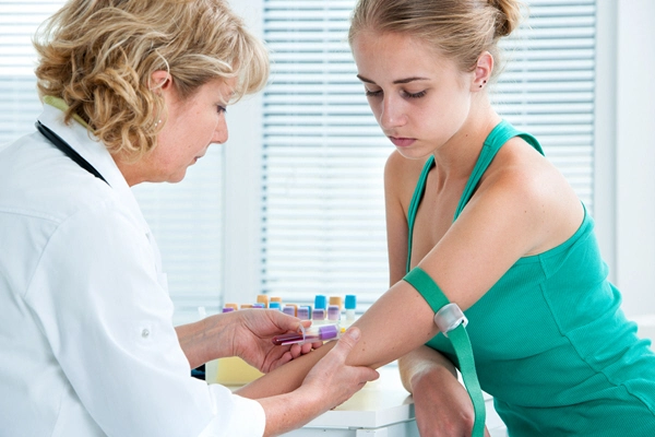 nurse taking blood sample from patient at the doctors office 1