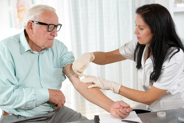 nurse with syringe is taking blood for test at the doctor office