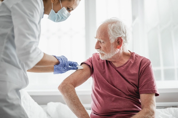 portrait of bearded old man receiving shot