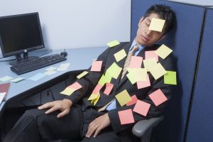 businessman asleep at desk with notes_HFCbCfCrs 300x200